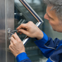 Male Lockpicker Fixing Door Handle At Home Mature Male Lockpicker Fixing Door Handle At Home